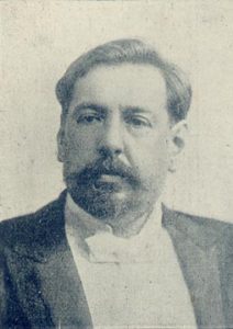 foto de José Battle y Ordóñez; tiene bigotes y una barba corta y lleva un traje formal con corbata blanca